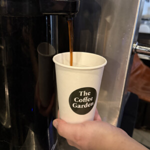 Fresh drip coffee being poured into a The Coffee Garden cup at our Uptown Houston coffee shop.