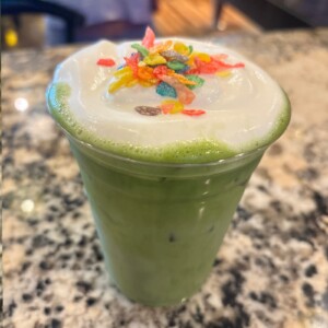 Fruity Pebble Matcha with cold foam and fruity cereal at The Coffee Garden in Uptown Houston.