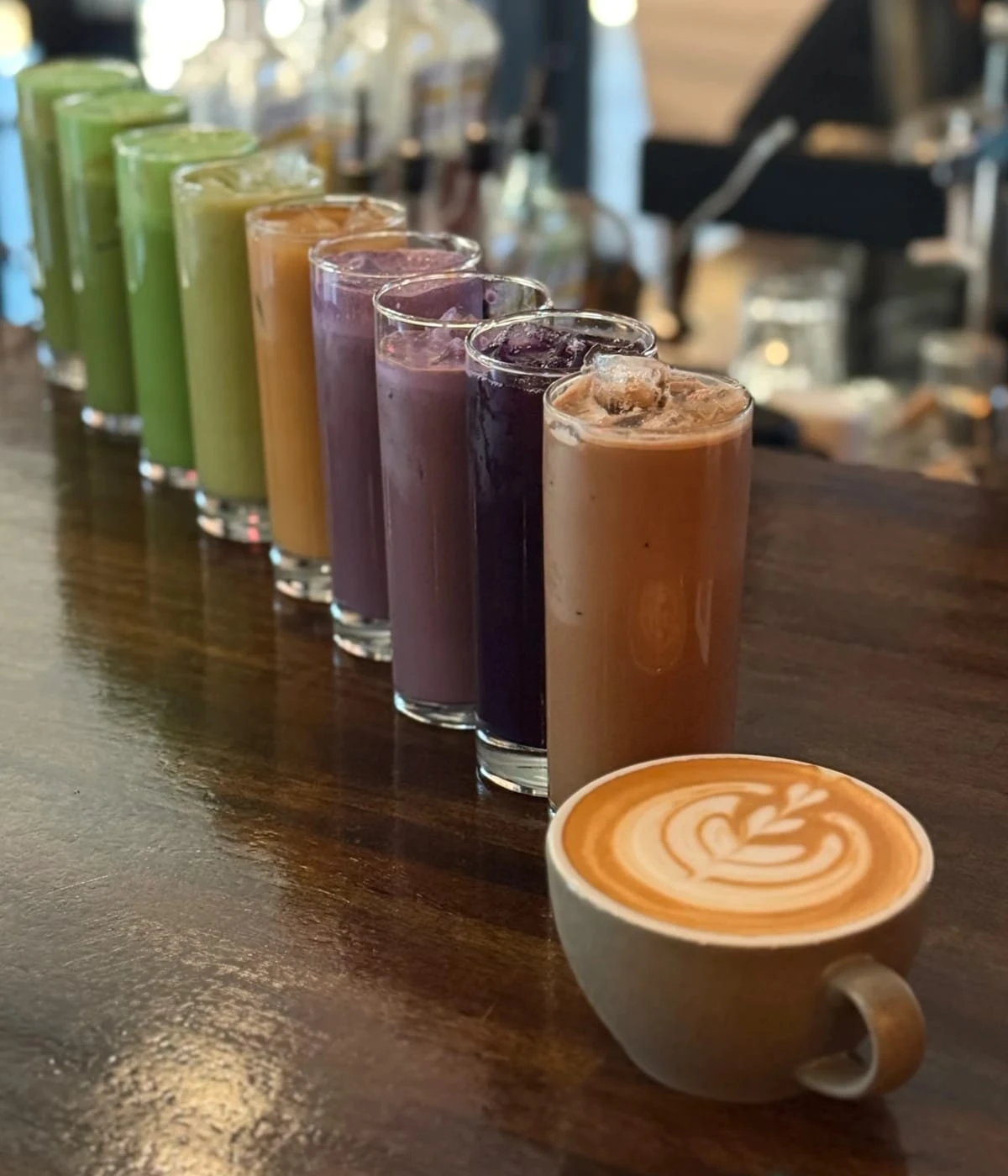 Heights Coffee Shop signature drinks—nine iced lattes and one hot latte in ceramic