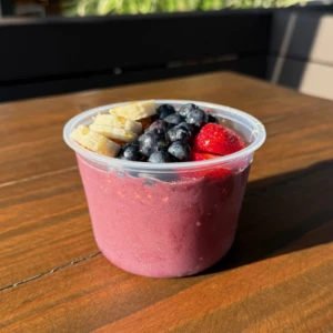 Acai bowl topped with strawberries, blueberries, banana, granola, and honey at The Coffee Garden in the Heights, Houston TX 77007.