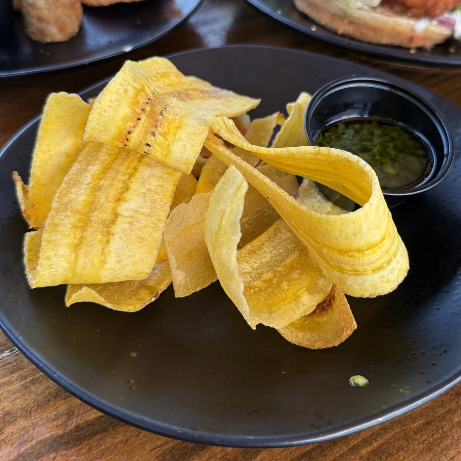 Handmade plantain chips served with chimichurri sauce at The Coffee Garden in the Heights, Houston TX 77007.