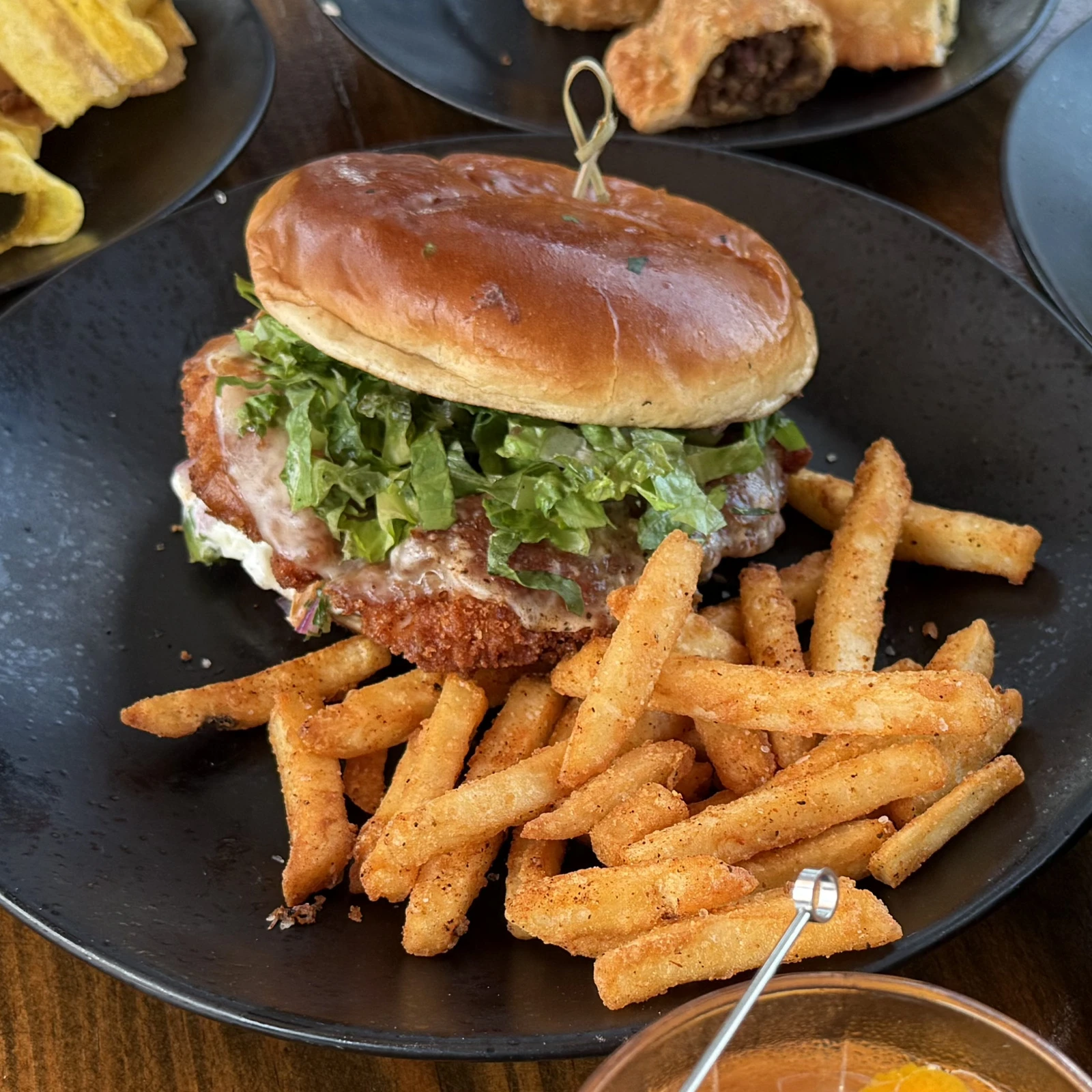 Latino Chicken Sandwich with plantain-crusted chicken, provolone cheese, lettuce, and fries at The Coffee Garden in the Heights, Houston TX 77007.
