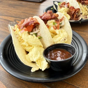Breakfast tacos with scrambled eggs, crispy bacon, pico de gallo, and salsa at The Coffee Garden in the Heights, Houston TX 77007.